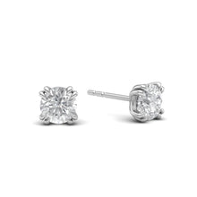 Load image into Gallery viewer, One-carat diamond stud earrings set in 18 karat white gold rhodium polished with classic four-prong claw settings, showcasing timeless elegance and brilliance.

